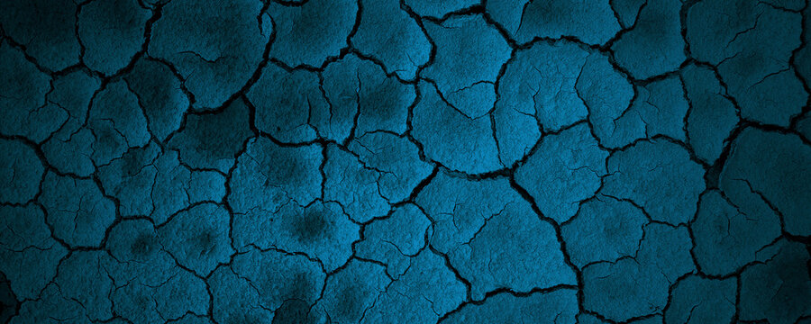 Blue parched cracked earth soil pattern dry arid surface textured rugged background. Suitable for naturethemed designs, desert landscapes, environmental concepts.