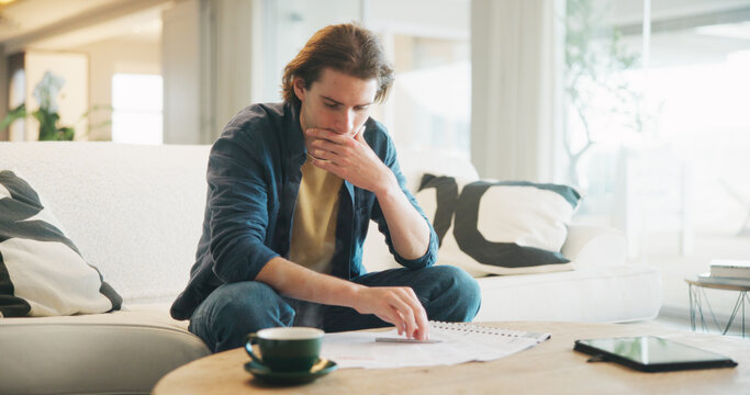 Man, stress and reading paperwork in home for financial mistake, bankruptcy or mortgage debt. Worried, confused and person on sofa with decision, thinking or planning for documents of bills or loan