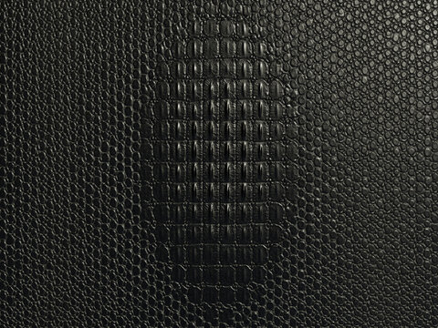 Black crocodile leather texture background with embossed alligator skin pattern