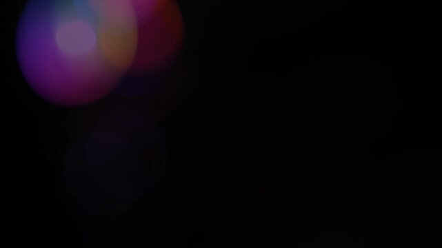 Colorful lens flare bokeh on dark background, Abstract multicolor lens flare bokeh circles on dark black background with copy space