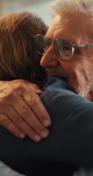 Senior father, son and hug in home for support, love and bonding together on sofa. Relax, happy men and elderly person with embrace for respect, care or comfort on weekend in living room with smile