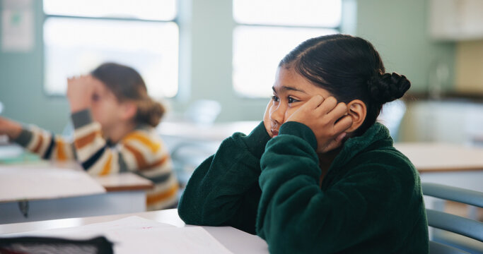 Bored, learning and child thinking in classroom for course, development and knowledge at school. Tired, kid and girl in elementary for education with reflection, idea or distracted student at lesson