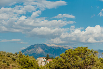 Fototapeta premium Mount Tomorr rising above rural landscape near Berat, Albania