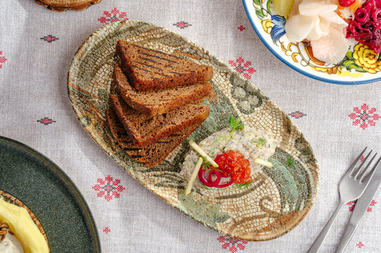 Top view of herring forshmak with caviar and rye bread