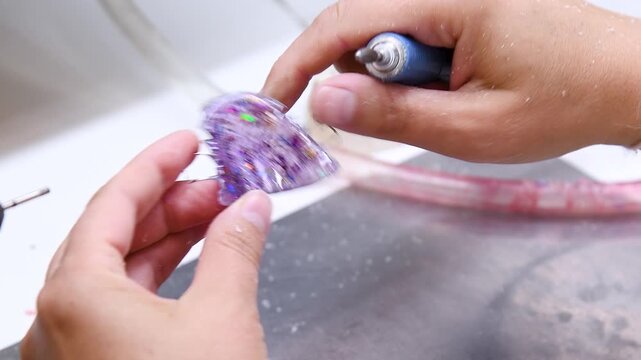 A person is engaged in the manufacture of a denture or a model of teeth.