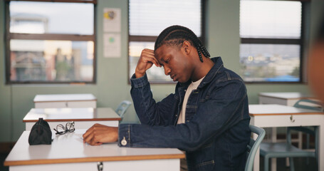 School, bored and tired black man in classroom for lesson, learning and studying at desk. Stress,...
