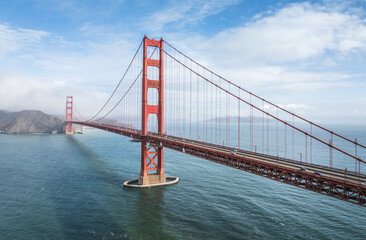 Obraz premium Aerial view of the foggy cityscape of Golden Gate Bridge in San Francisco, California, USA