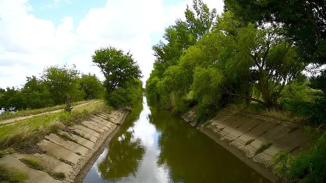 The canal is used for irrigation and water supply to agricultural fields.
