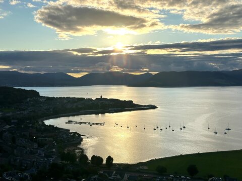 Sun setting over Gourock town and the Firth of Clyde with boats, Scotland, United Kingdom, August 2025