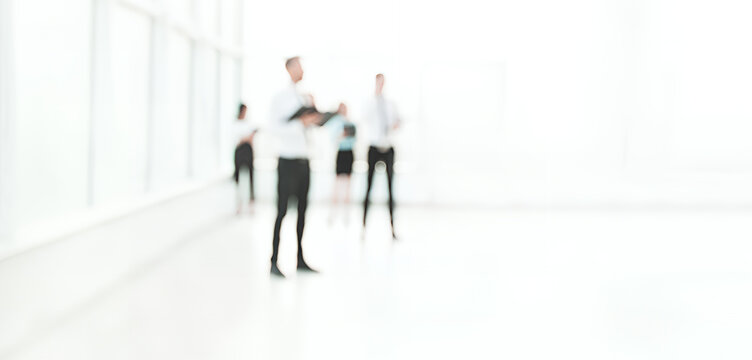 Blurred Business Professionals In Modern Office Interior
