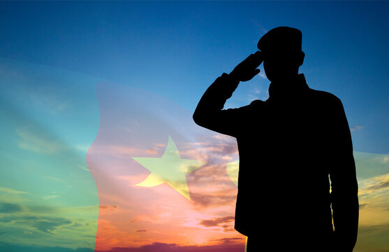 Silhouette of soldier on background of sunset with Cameroon flag. Background for National Holidays