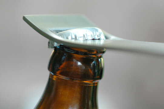 Bottle opener opening bottle, close-up