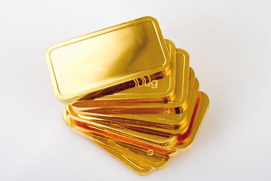 Gold bars on white background, elevated view