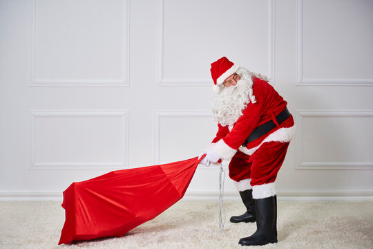 Santa claus pulling heavy sack