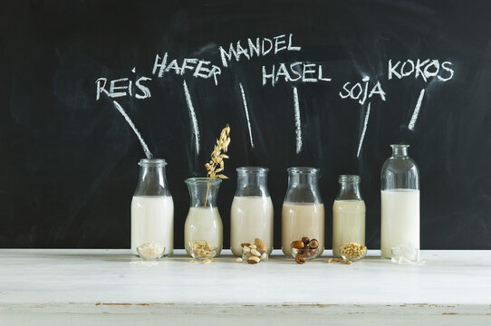 Glass bottles of various vegan milks
