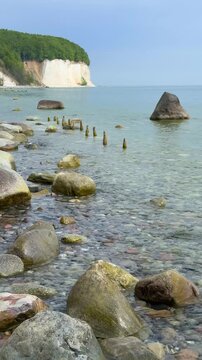 Famous white chalk cliffs and rocky Baltic Sea coastline in Jasmund National Park on Rugen island, Germany. Iconic natural landmark and coastal travel destination concept.