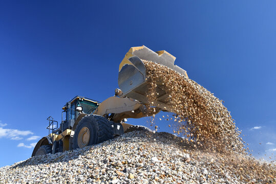 Wheel loader loading stones in gravel pit