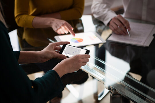 Business people at meeting in office using portabel devices