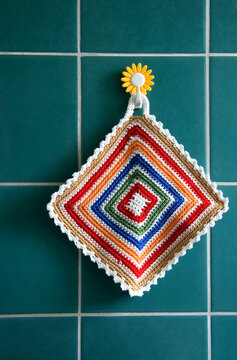 Pot holder hanging on tiled wall, close-up