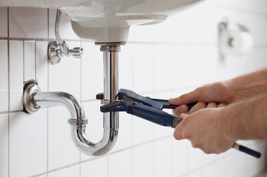 Man repairing sink pipe