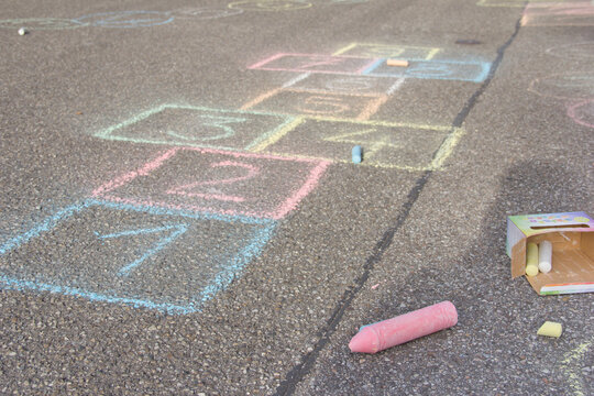 Hopscotch drawing with coloured crayon on asphalt