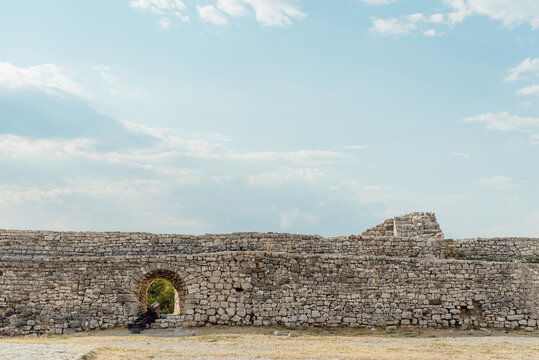 Stone fortress wall with cannon opening at Berat Castle in Albania