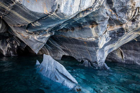 Stunning marble cave formations on a turquoise lake