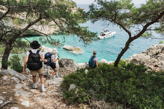 Three women hiking on a scenic coastal path