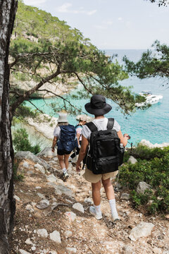 Group of friends hike down a coastal trail