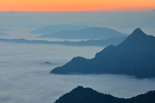 Silhouette of majestic mountain against dramatic sky