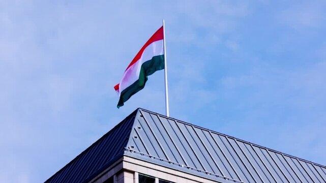 Huge Italian flag flying in the wind onto of the embassy building in Berlin