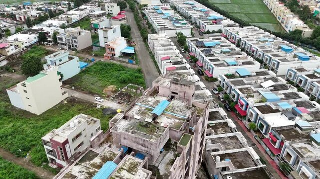 Cinematic drone perspective of residential buildings, well-planned roads, and houses in Katara Hills.