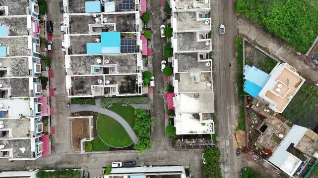 Cinematic drone perspective of residential buildings, well-planned roads, and houses in Katara Hills.