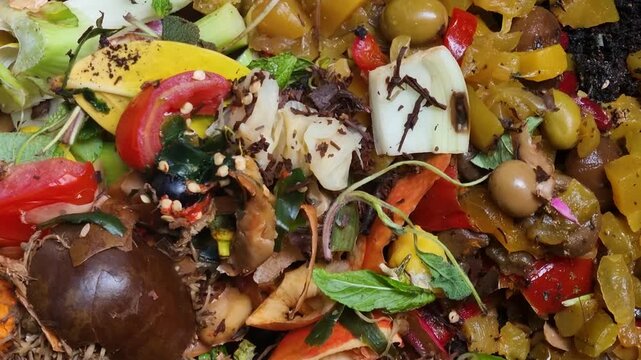 Detailed shot of organic kitchen scraps and garden waste inside a compost bin, showcasing eco-friendly food recycling, biodegradation, and sustainable compost production for healthier soil