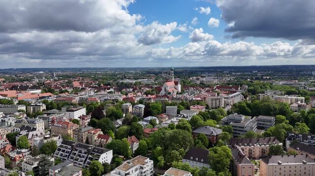 Smooth high altitude drone orbit keeping Augsburg church centered in frame.