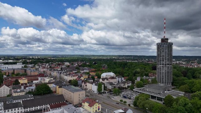 Wide aerial scene showing Augsburg Hotelturm, congress buildings and expansive park surroundings.