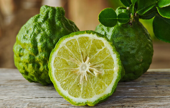 Fresh kaffir lime fruit on a wooden floor.