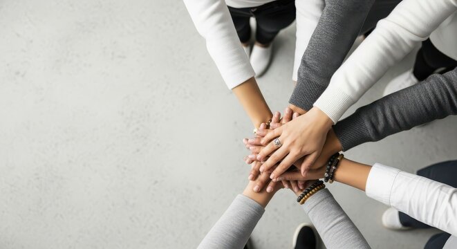 Diverse Group of People Stacking Hands Together for Teamwork and Unity Concept with Copy Space