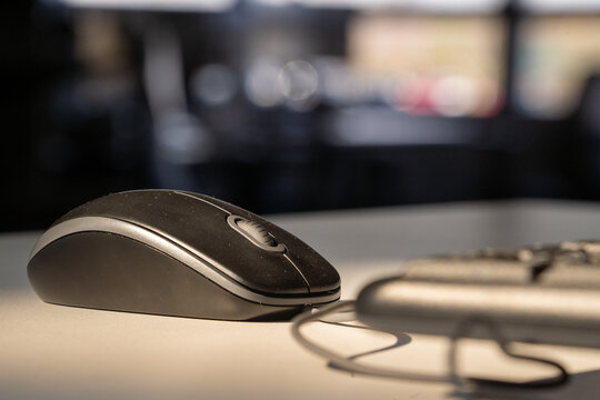 computer mouse and keyboard on desk in natural light