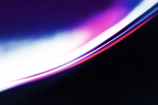 Abstract close-up of soft curves in vibrant purple and blue tones.