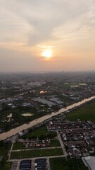 Fototapeta premium Aerial view of cityscape with river at sunset