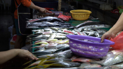 Fresh Fish Display with Vendor at a Traditional Manila Wet Market © blueringmedia
