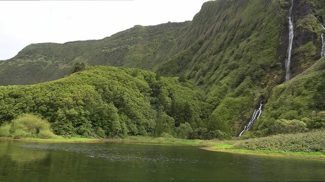 Waterfalls of Po&ccedil;o da Ribeira do Ferreiro, panorama over the green mountains, Fajanzinha, Flores island in the Azores archipelago, Portugal.