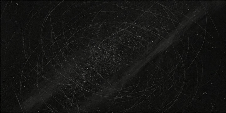 A dark, scratched blackboard surface, filled with faint chalk marks and swirls, suggests a history of lessons and ideas.