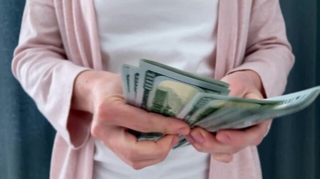 The woman counts the money. Savings and thrift. The theme of saving, sound financial management and striving for financial stability