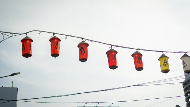 Traditional red lanterns hanging in urban street setting