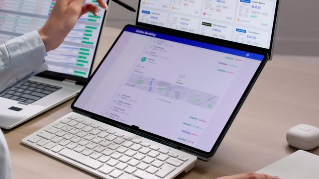 Accountant Reviewing Multiple Financial Reports On Laptop