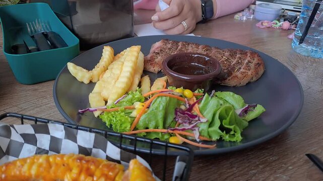 Gourmet steak house platter featuring Rib Eye, Sirloin, and Ribs Corn with a large double-meat burger. Cinematic camera movements from close-up to eagle eye view. Luxury dining experience. 4K.