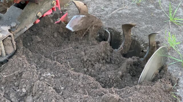 Agricultural power tiller cultivating soil for planting