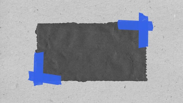 Dark charcoal paper scrap with blue tape corners on textured grey background for creative motion graphic video animation project